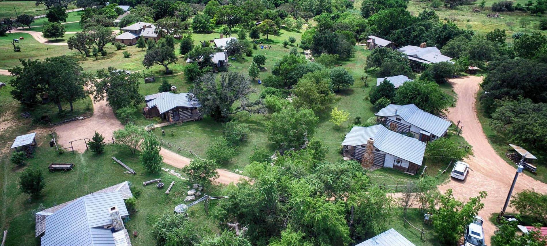 Picture of log cabins from the air.